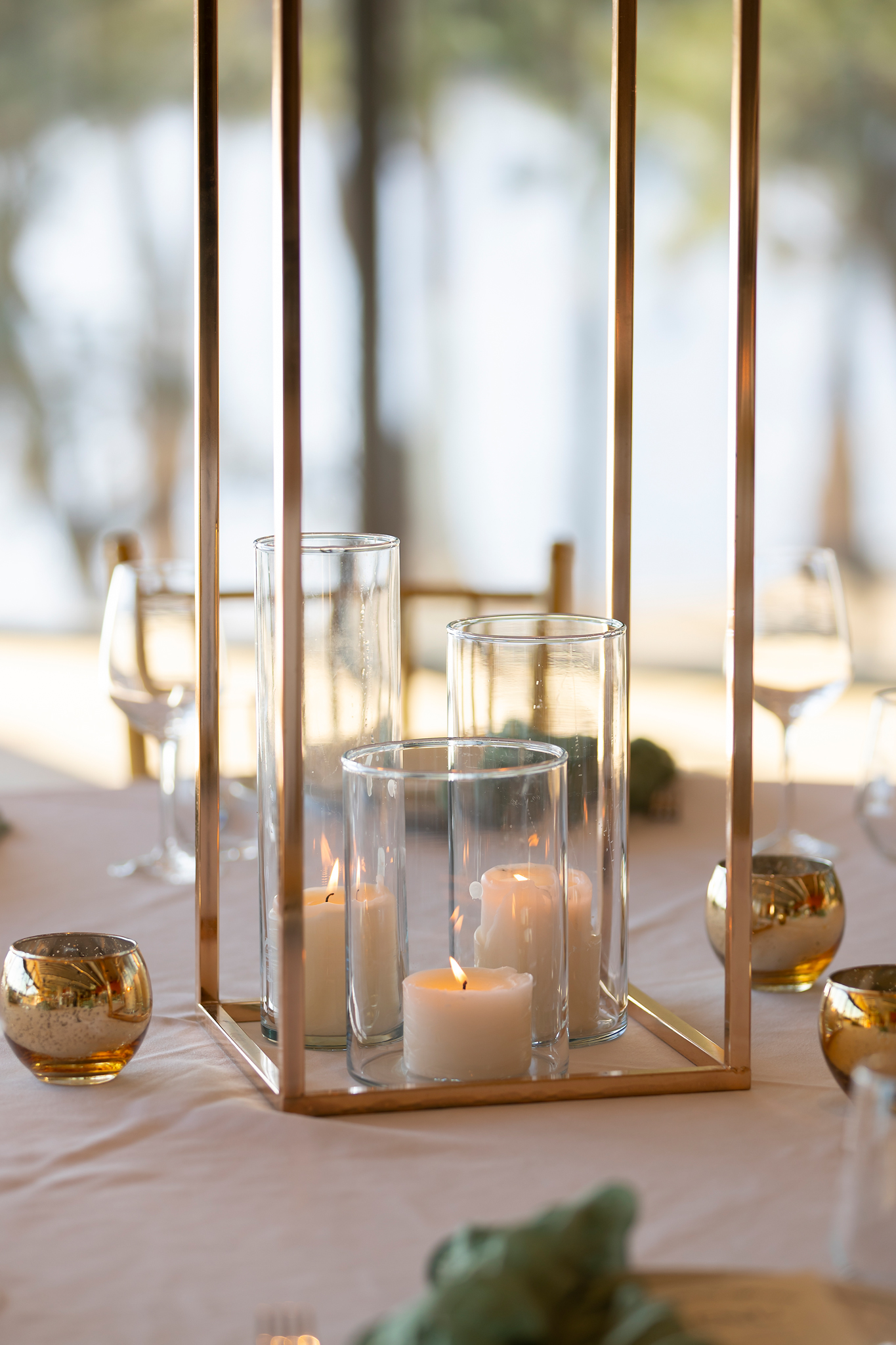 Tall glass candlesticks on a dressed dining table