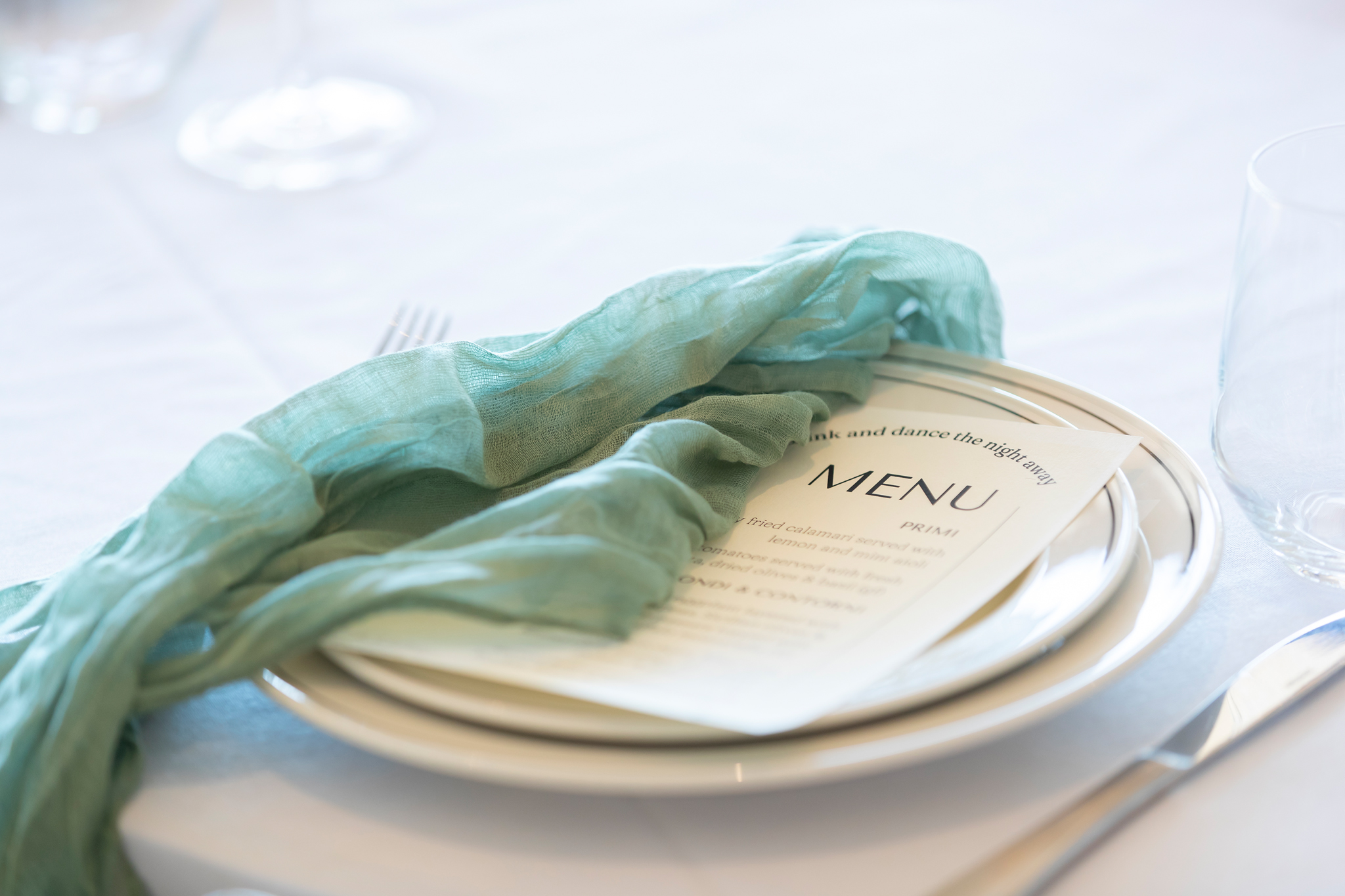 A place setting with printed menu at a private dinner