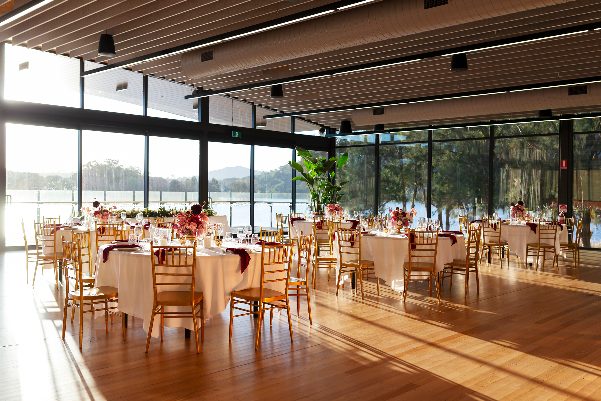 Round tables dressed for a celebration dinner in the Telopea Room
