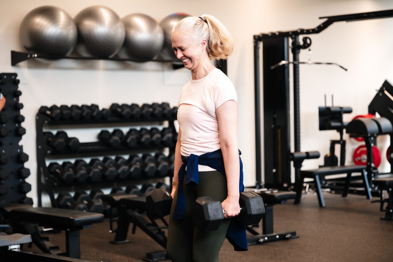 Member laughing mid dumbbell set at RSX gym