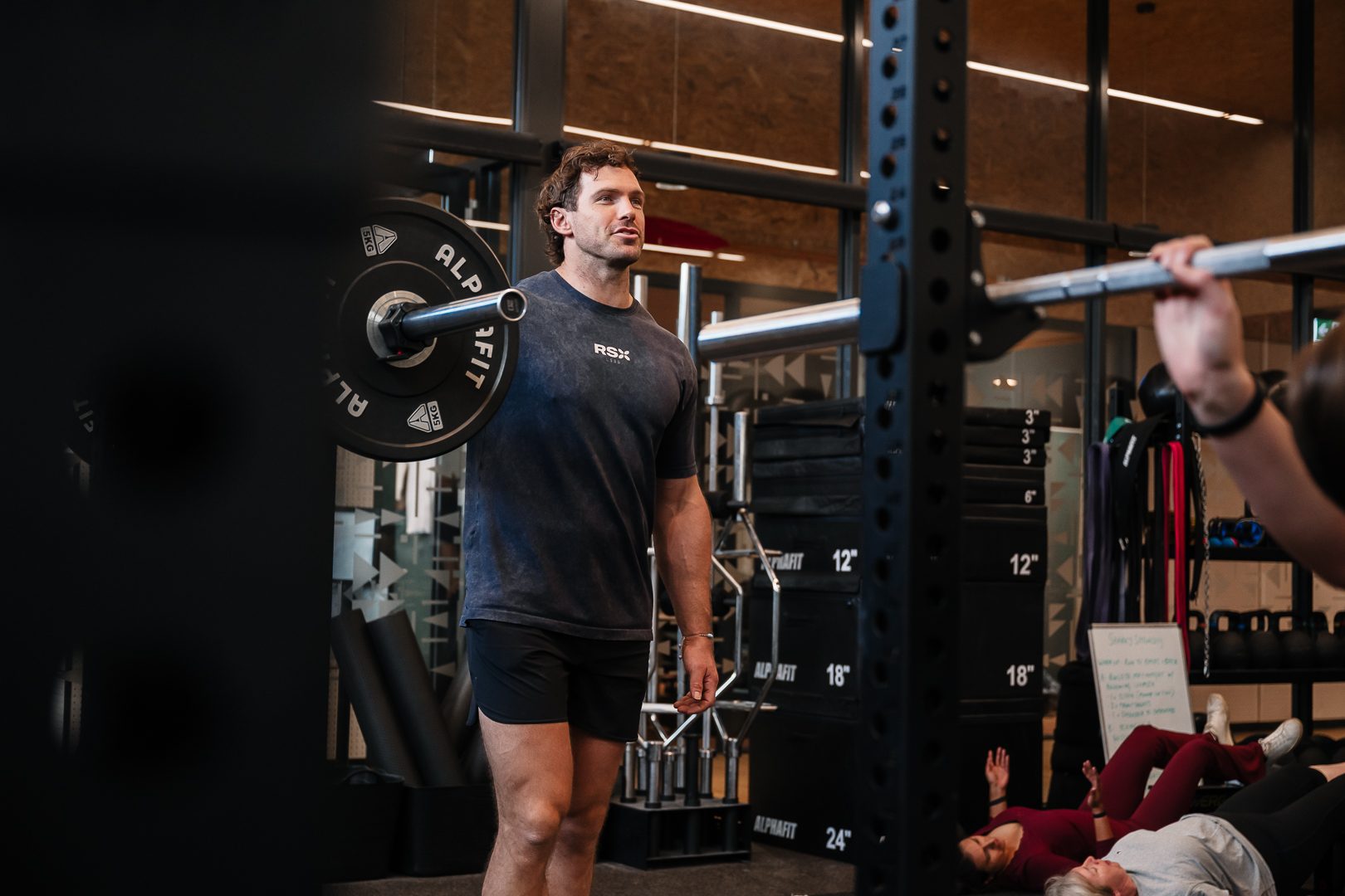 A young RSX coach loading a barbell