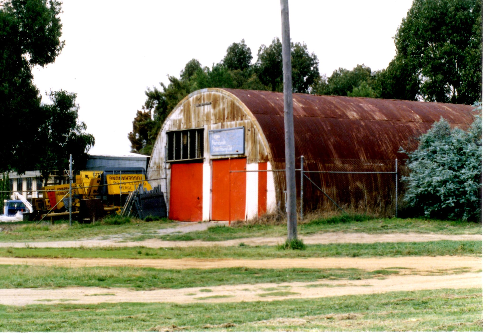 The original Narrabundah rowing club Nissen hut with its red doors