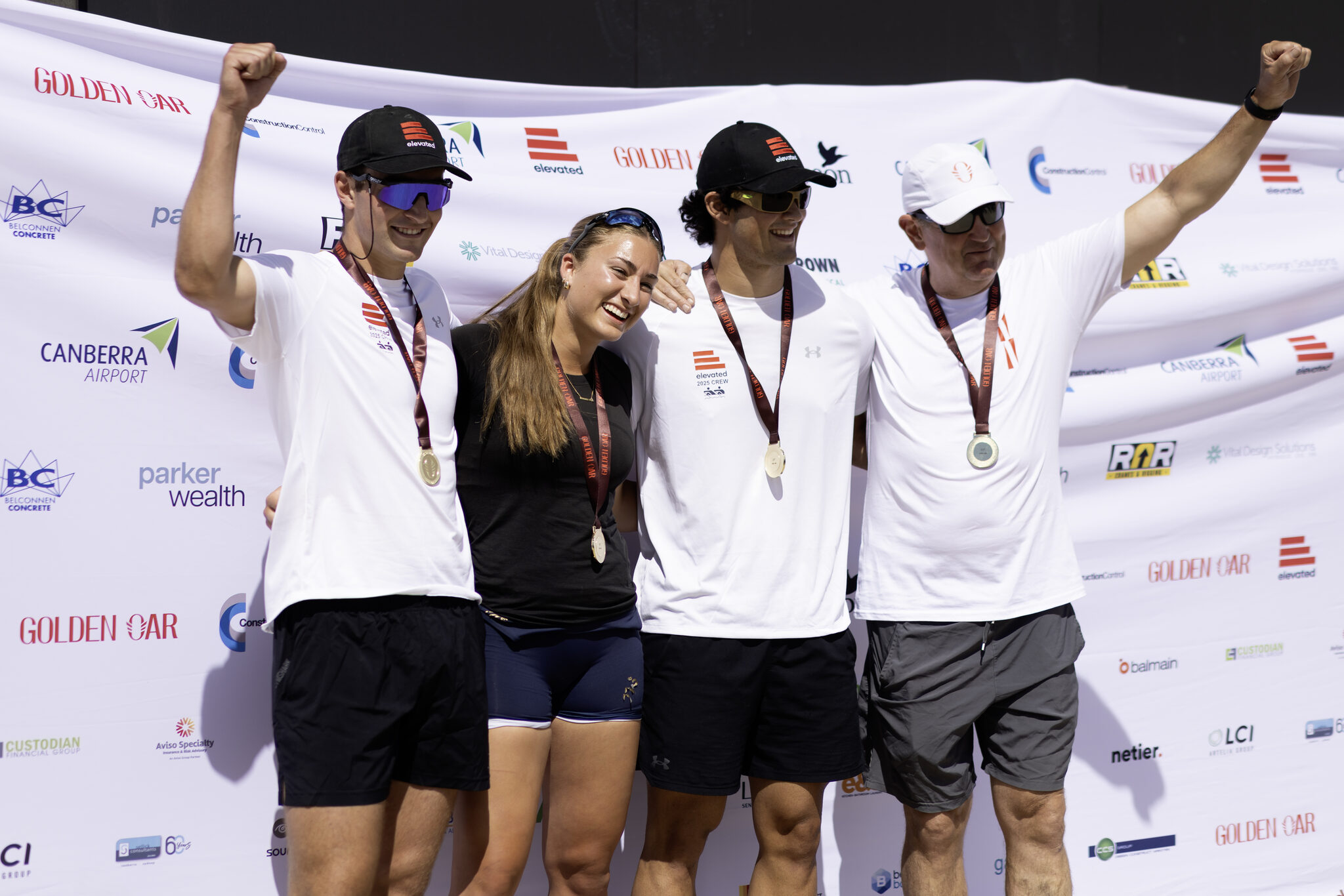 A corporate crew on the podium with their medals at the Golden Oar