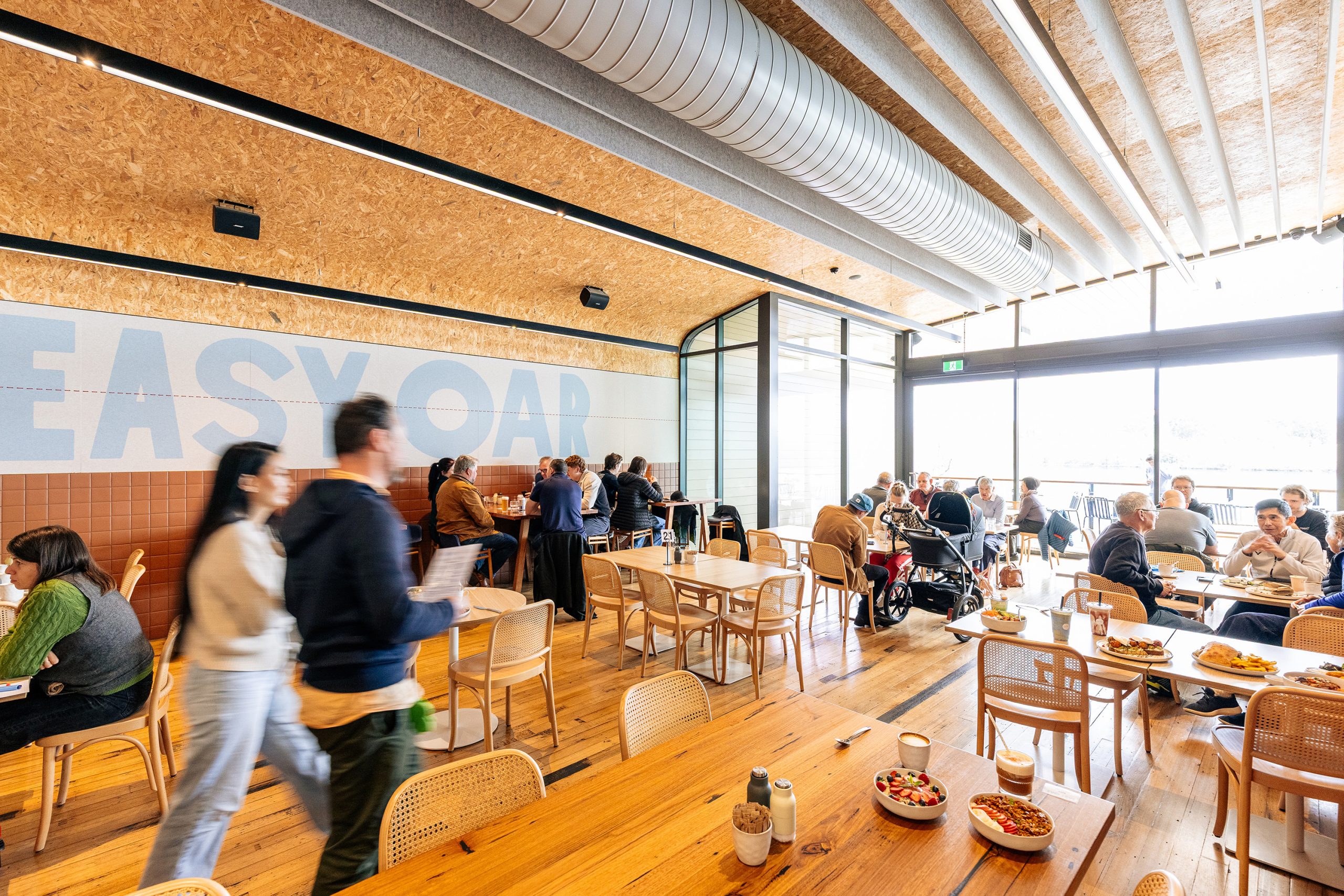 Inside Easy Oar: a full cafe beneath the Easy Oar mural