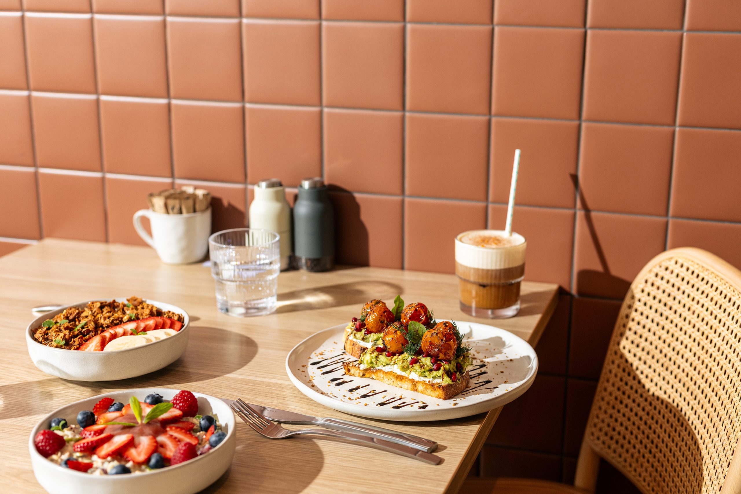 Granola bowls, avocado toast and coffee in the morning sun at Easy Oar