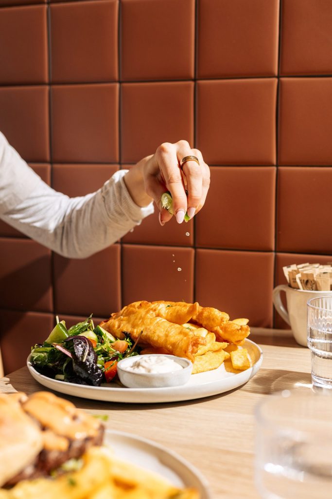 Lemon squeezed over beer-battered fish and chips at Easy Oar