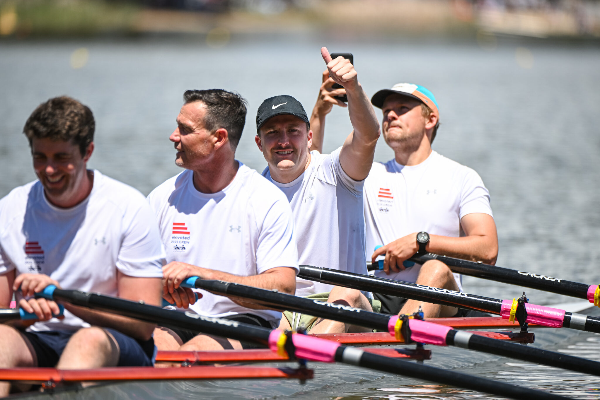 A corporate crew celebrating in their boat after racing at the Golden Oar