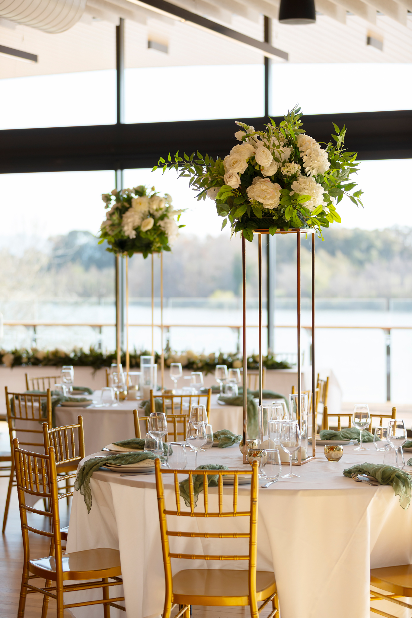 A white floral centrepiece on a long dining table